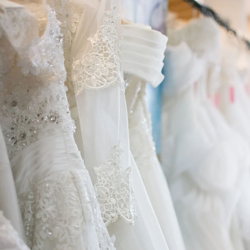 Wedding gowns hanging in dry cleaner