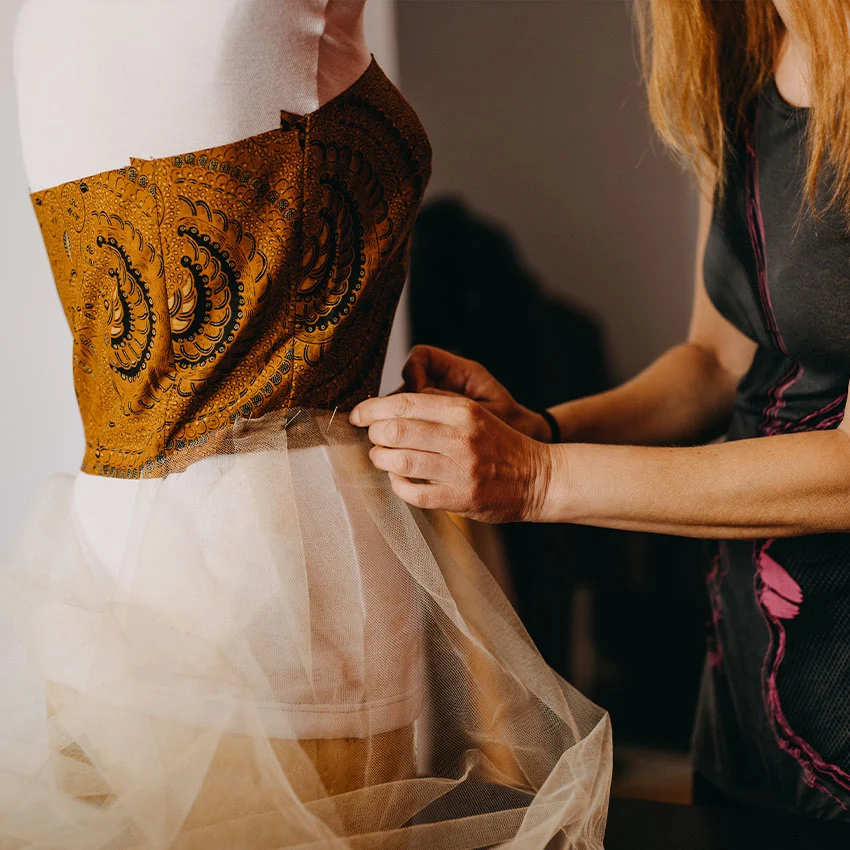 Tailor working on dress alteration